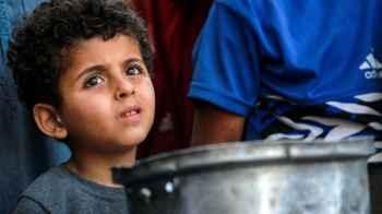 A child bears in his eyes the silent scream of hunger
