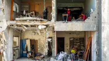 Amid the ruins… a family mourns its stolen memories