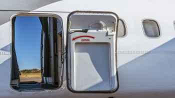 Passenger attempts to open airplane door mid-flight