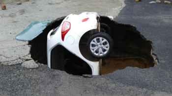 Ground collapse swallows car, owner reacts with joy – video