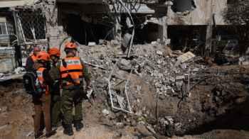 Scenes of streets shrouded in destruction and residents cloaked in fear in Tel Aviv