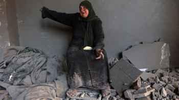On top of the destroyed stones.. a woman relives a life stolen by war